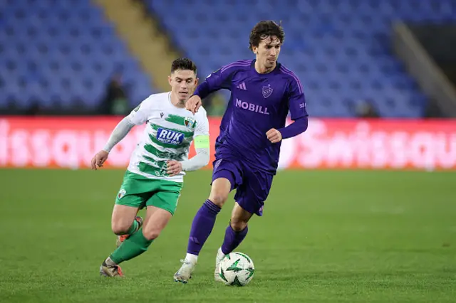 Gustav Wikheim of Djurgarden runs with the ball whilst under pressure from Daniel Redmond