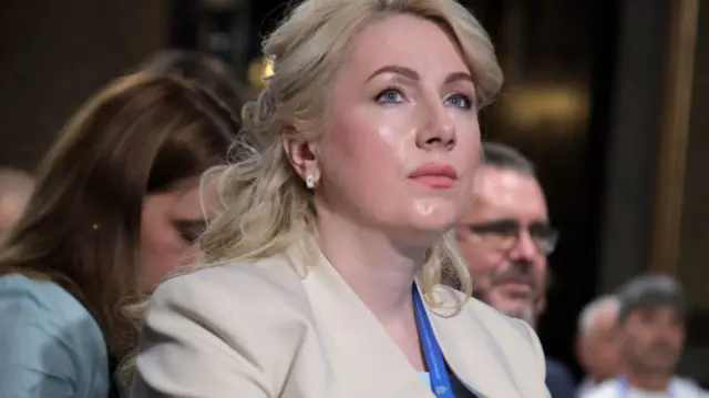 Svitlana Onyshchuk, governor of Ivano-Frankivsk region, shot from chest up, looking off camera, wearing a beige jacket. People in background blurred.