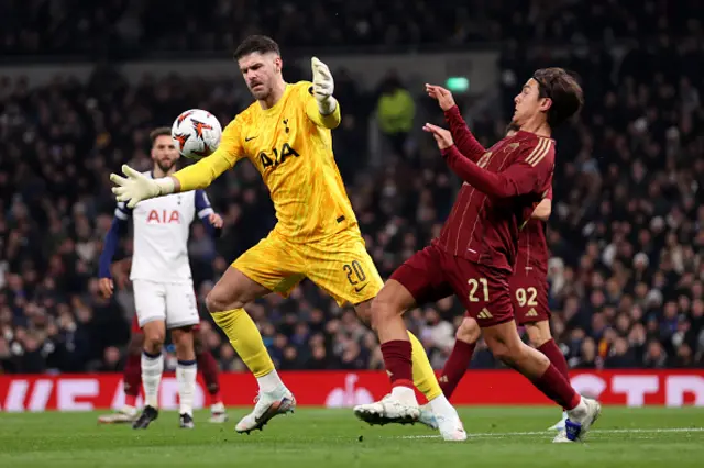 Fraser Forster of Tottenham Hotspur and Paulo Dybala of AS Roma compete