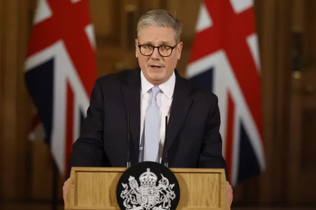 Starmer speaks at a podium in No 10