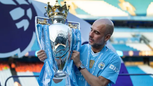 Pep Guardiola with the Premier League trophy