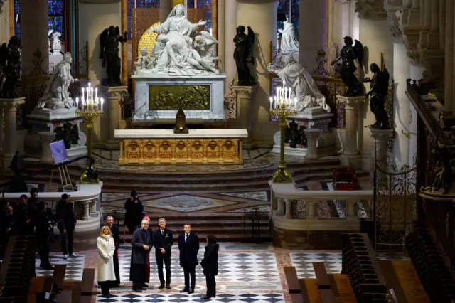 The group examining some of the statues that make up the Vow of King Louis XIII.