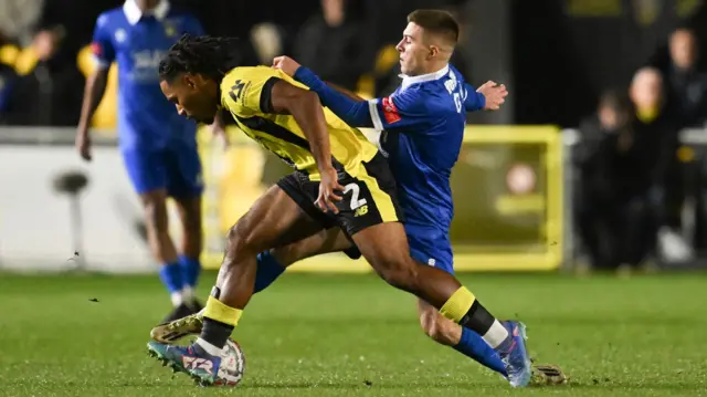 Zico Asare of Harrogate Town and Jordan Helliwell of Gainsborough Trinity