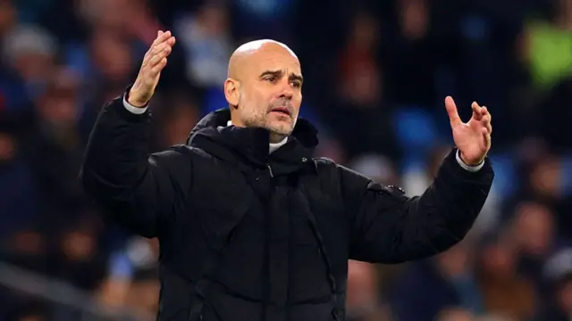 Man City manager Pep Guardiola gestures with his hands