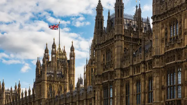 A union flag flutters over the Houses of Parliament