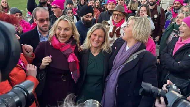 Labour MP Kim Leadbeater (centre) and Rebecca Wilcox (right), daughter of Esther Rantzen, among supporters of Dignity in Dying as they celebrate the result of the vote