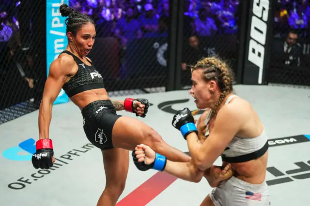 Talia Santos lands a kick to the stomach of Jena Bishop