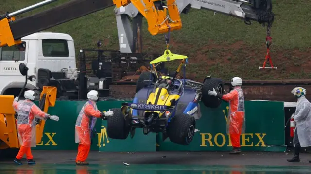 The car of Williams' Argentine driver Franco Colapinto is removed from the track after an accident during the qualifying session