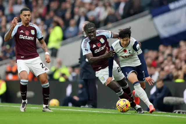 Son Heung-Min of Tottenham Hotspur controls the ball under pressure from Amadou Onana