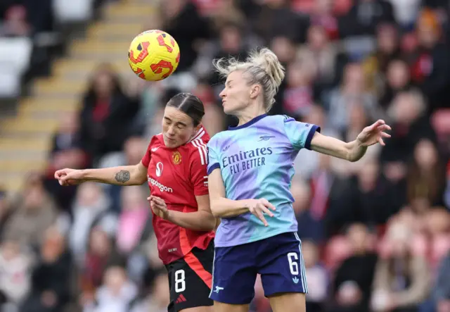 CLinton and Williamson duel for the ball in the air