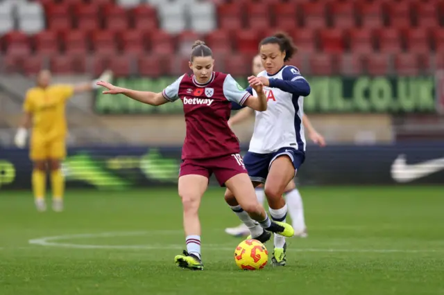 Denton and Spence battle for the ball in midfield