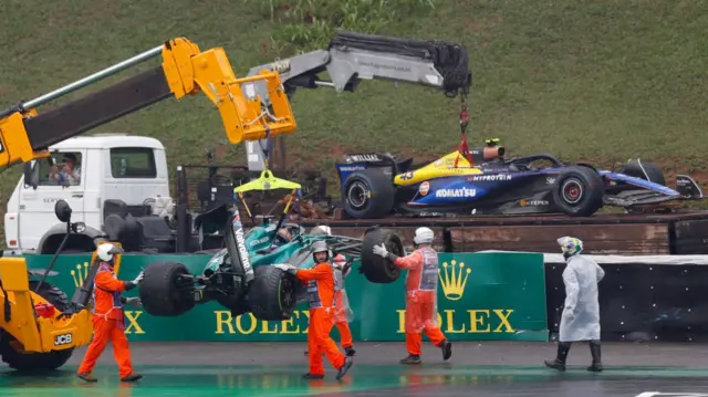 he cars of Aston Martin's Canadian driver Lance Stroll (front) and Williams' Argentine driver Franco Colapinto are removed from the track after their accidents during the qualifying session