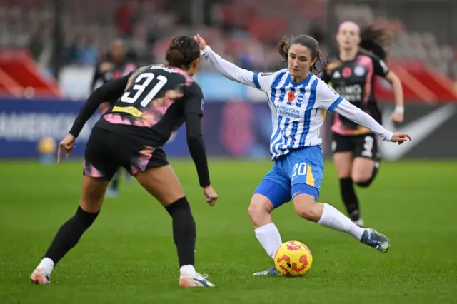 Bruna plays the ball for Brighton