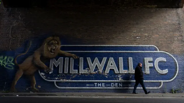 A mural depicting the Millwall Lion showing the way to The Den