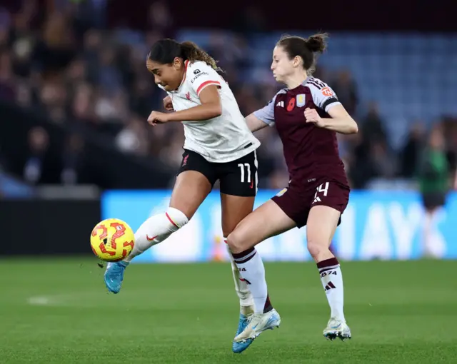 Olivia Smith of Liverpool controls the ball whilst under pressure from Danielle Turner of Aston Villa