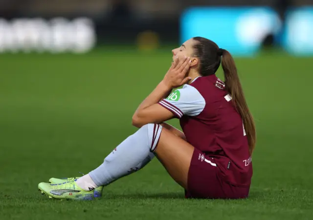 Piubl sits on the floor with head in hands