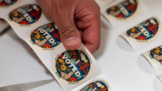 Round tan stickers feature illustrations of various California symbols and text that reads "I voted!"