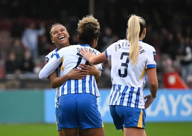 Brighton players hug Parris after her opening goal