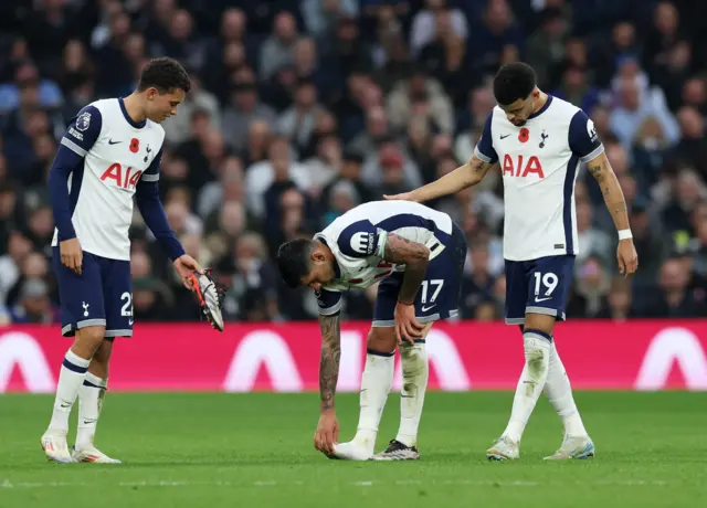 Tottenham Hotspur's Cristian Romero reacts after sustaining an injury