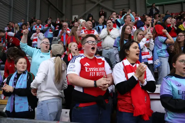 Arsenal fans cheer in the stands