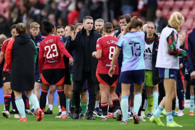 Marc Skinner congratulates his players on the pitch at full time