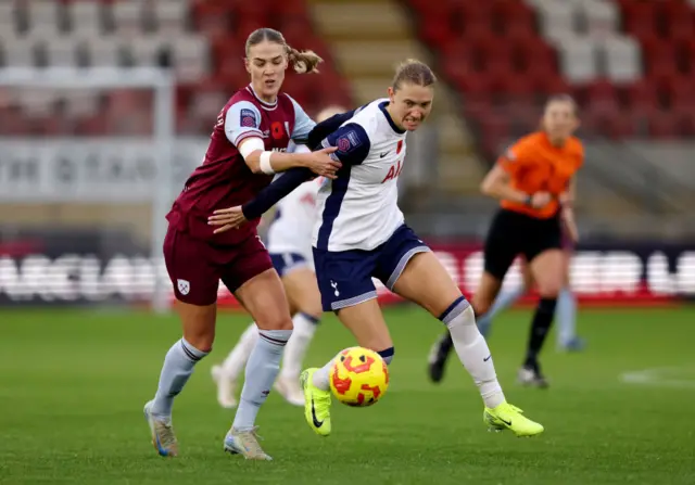 Brynjarsdottir tackles Graham in midfield