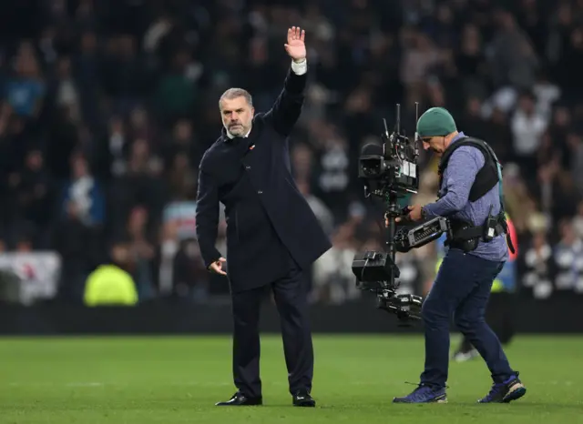 Ange Postecoglou, Manager of Tottenham Hotspur, waves to the fans