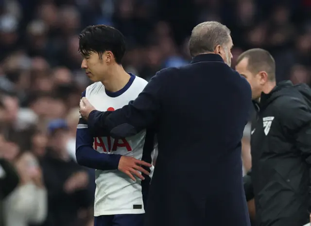 Tottenham Hotspur's Son Heung-min looks dejected with manager Ange Postecoglou after being substituted