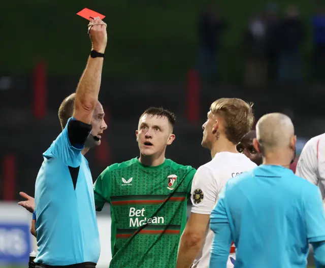 James Singleton is shown a red card