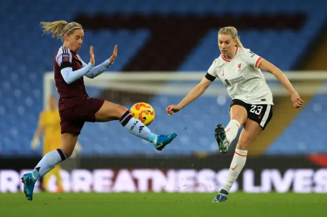 Gemma Bonner kicking the ball as Jordan Nobbs tries to block