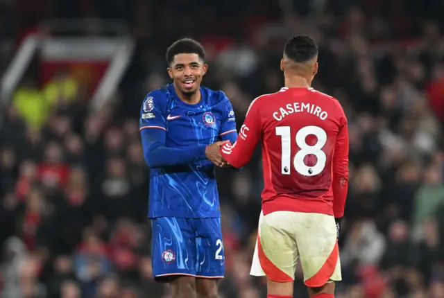 Wesley Fofana of Chelsea shakes hands with Casemiro of Manchester United