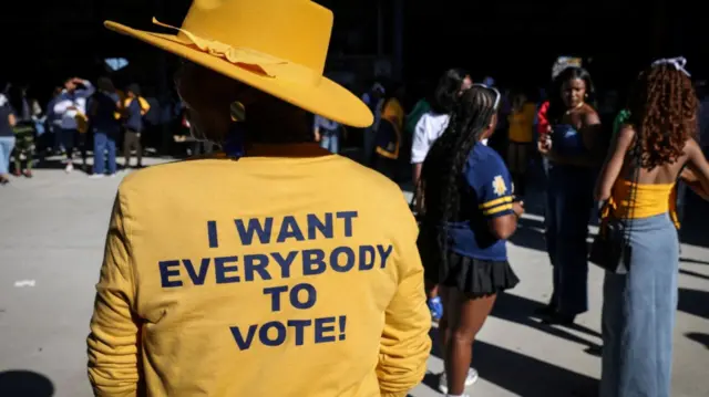 Grace Garrett, an alum, wears a shirt reading "I want everybody to vote!" as she poses for a portrait during the homecoming football game at North Carolina Agricultural and Technical State University in Greensboro, North Carolina