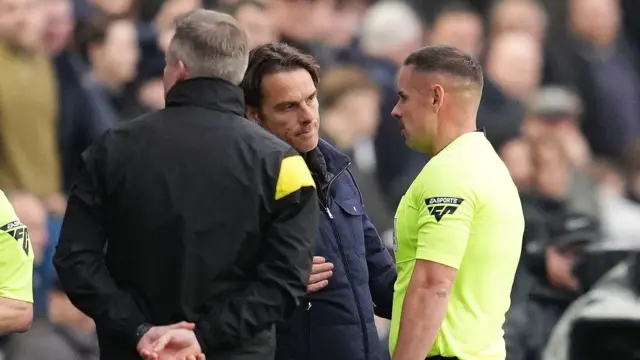 Assistant referee talks to Burnley boss Scott Parker