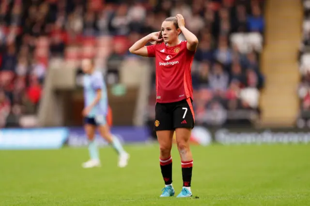 Toone puts her hands to her head as she reacts to a missed chance