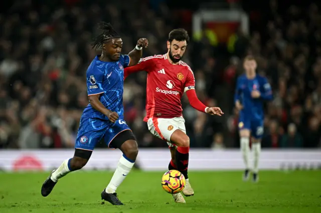 Romeo Lavia vies for the ball with Manchester United's Portuguese midfielder #08 Bruno Fernandes