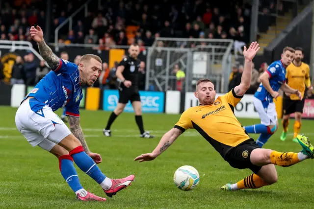 Carrick's David Cushley attempts to block a Kirk Millar shot