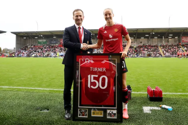 Turner is presented with a '150' shirt to mark her 150th appearance