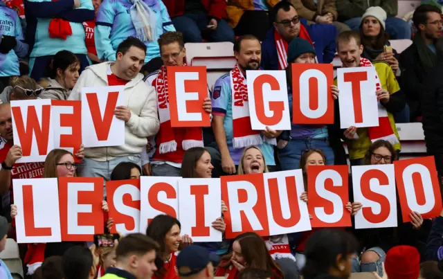 Arsenal fans hold up a banner in support of Russo