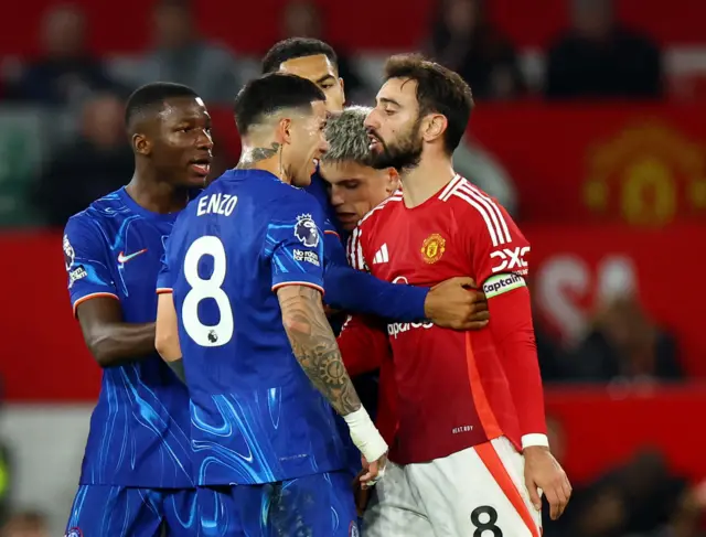 Chelsea's Enzo Fernandez clashes with Manchester United's Bruno Fernandes