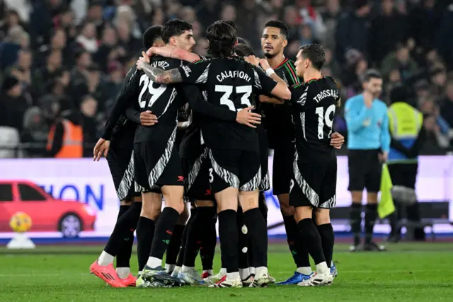 Arsenal players celebrate after scoring against West Ham