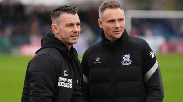 Wycombe boss Matt Bloomfield chats with Wealdstone manager Matt Taylor