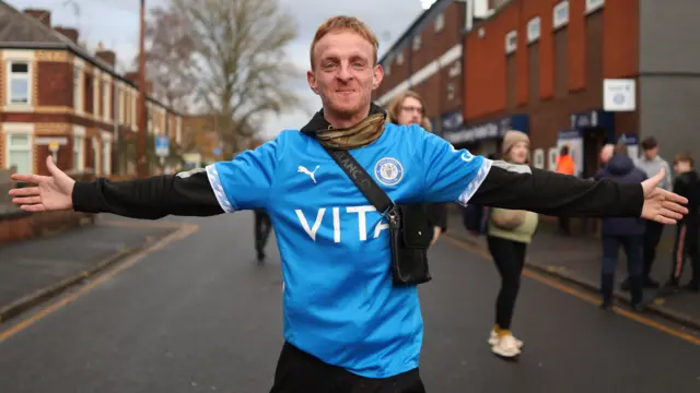 A Stockport Countyfan arrives at Edgeley Park ahead of their FA Cup tie against Brackley