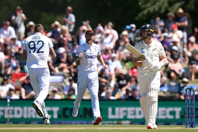 Brydon Carse and Ben Stokes celebrate the wicket of Matt Henry