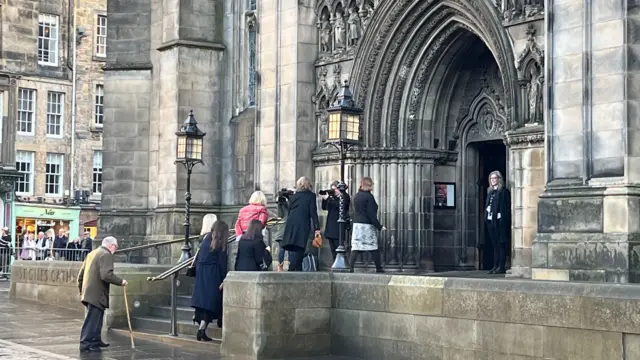 Seven guests climb the stairs before entering the front of the cathedral