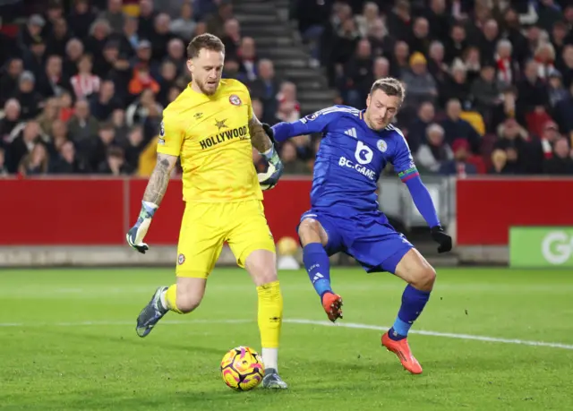 Leicester City's Jamie Vardy tries to tackle Brentford goalkeeper Mark Flekken.