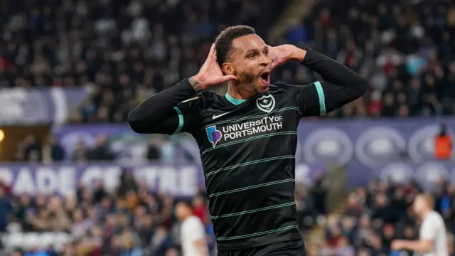 Josh Murphy holds his hands to his ears after scoring for Portsmouth