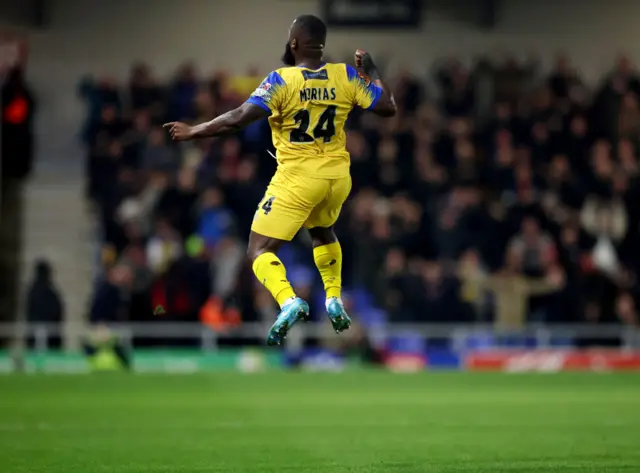 Junior Morias celebrates scoring at AFC Wimbledon