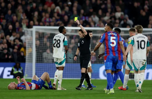 Newcastle United's Joe Willock is shown a yellow card.