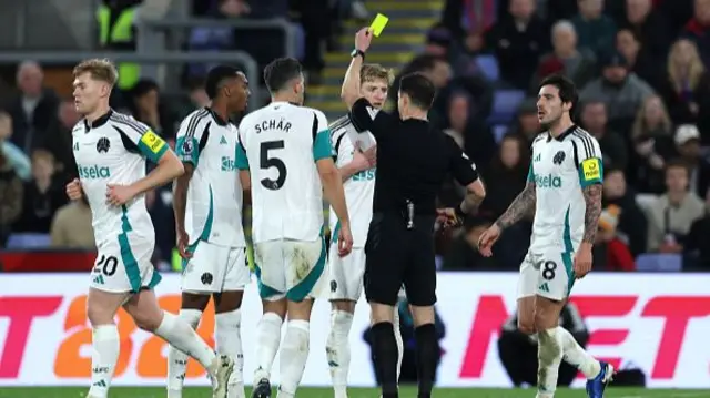 Anthony Gordon of Newcastle United is shown a yellow card.