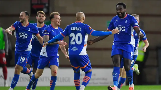 Manny Monthe celebrates with his Oldham team-mates